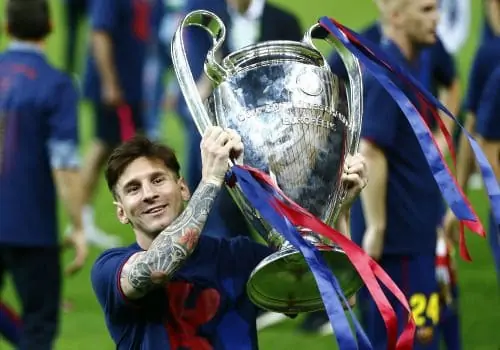 Lionel Messi smiles with the 2014-15 UEFA Champions League trophy.