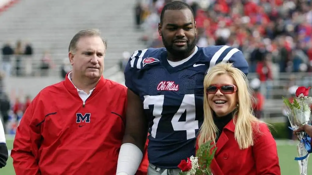 Michael Oher with his adoptive parents.
