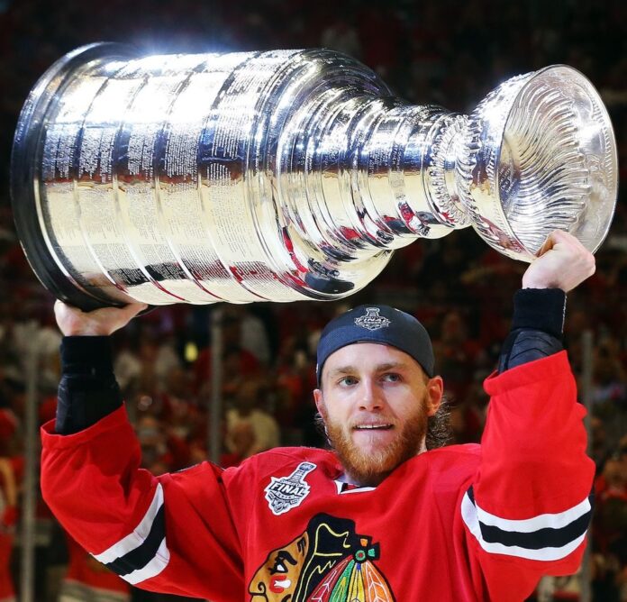 Patrick Kane holds the Stanley Cup after Blackhawks win, 2015.
