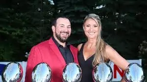 Raina Patricia with husband Matt posing alongside Super Bowl trophies