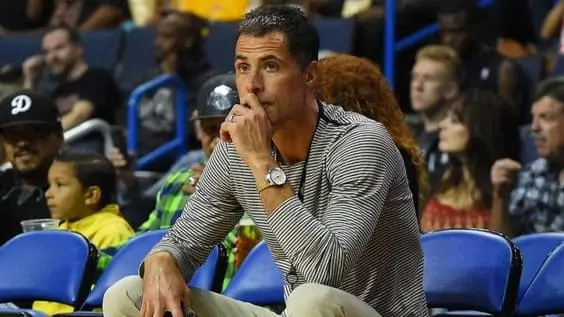 Rob Pelinka watches an NBA game from the seats.